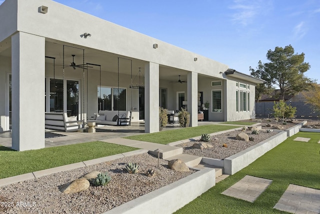 rear view of house with a yard, an outdoor hangout area, a patio, and ceiling fan