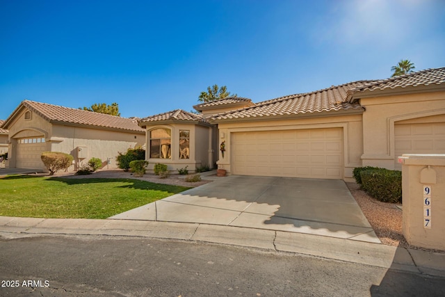 mediterranean / spanish-style home with a garage and a front lawn