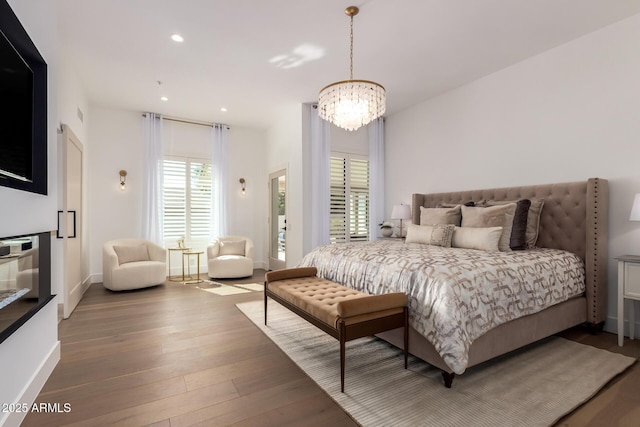 22756 N 91st Way, Scottsdale, AZ 85255 - bedroom with a chandelier, wood finished floors, recessed lighting, and baseboards