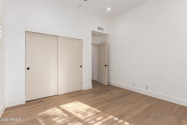 22756 N 91st Way, Scottsdale, AZ 85255 - unfurnished bedroom with baseboards, wood finished floors, a closet, and recessed lighting
