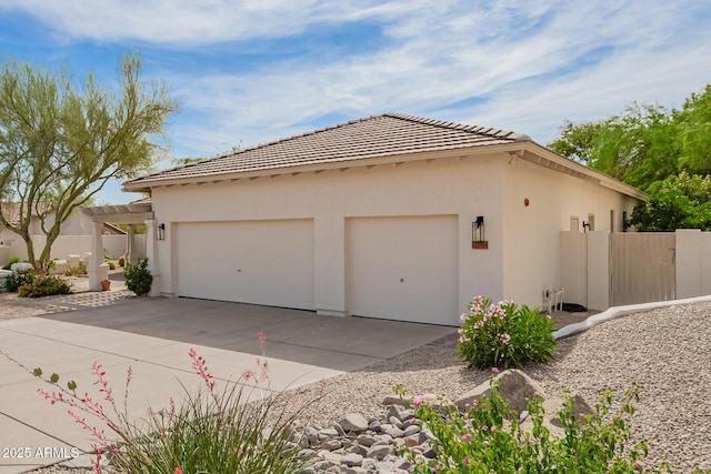 22756 N 91st Way, Scottsdale, AZ 85255 - view of property exterior with driveway, stucco siding, an attached garage, and a tiled roof