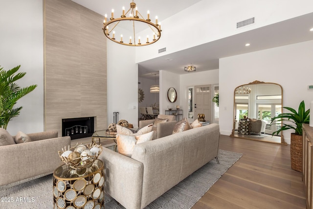 22756 N 91st Way, Scottsdale, AZ 85255 - living room featuring a high ceiling, wood finished floors, a chandelier, a premium fireplace, and recessed lighting