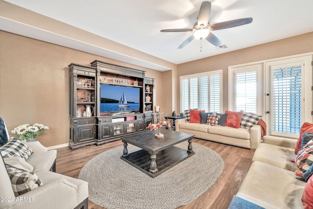 living room with hardwood / wood-style floors and ceiling fan