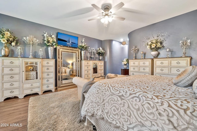 bedroom with ceiling fan and hardwood / wood-style floors