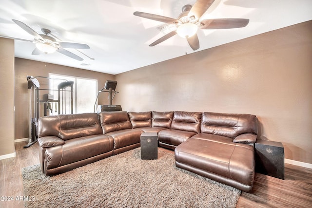 living room with wood-type flooring and ceiling fan