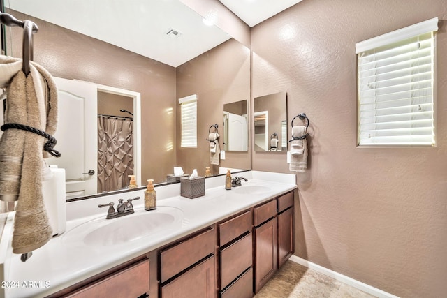 bathroom featuring curtained shower and vanity