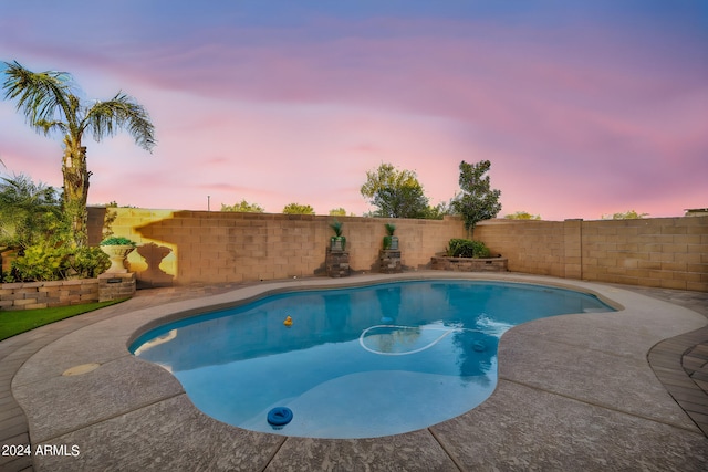 view of pool at dusk