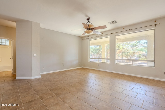 unfurnished room with light tile patterned flooring and ceiling fan