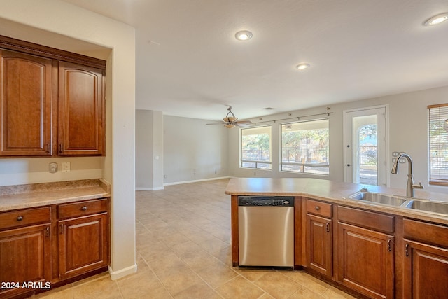 kitchen featuring light tile patterned floors, stainless steel dishwasher, sink, and ceiling fan