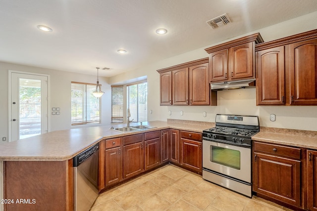 kitchen with a wealth of natural light, kitchen peninsula, appliances with stainless steel finishes, and hanging light fixtures