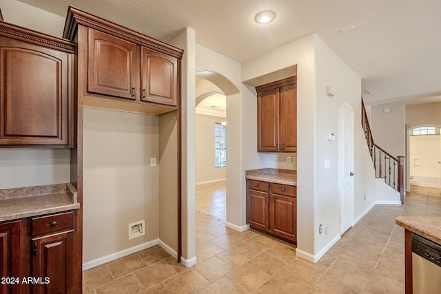 kitchen with stainless steel dishwasher and light tile patterned floors