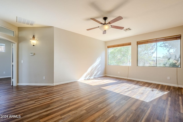 unfurnished room with dark hardwood / wood-style floors and ceiling fan