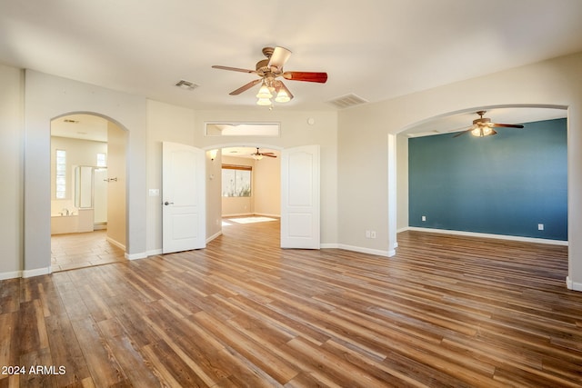 unfurnished room featuring hardwood / wood-style flooring and ceiling fan