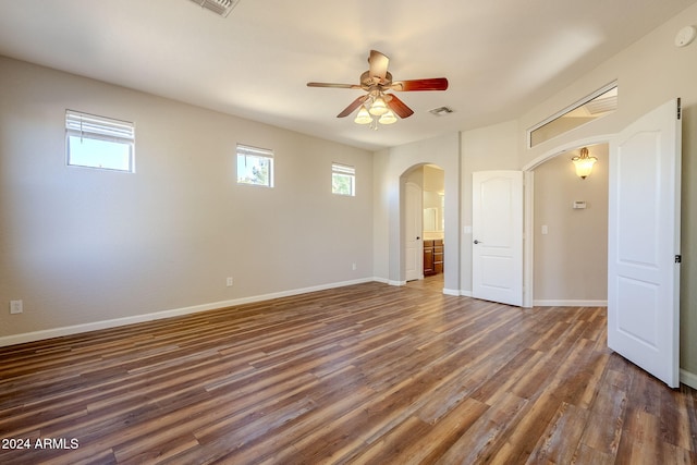 empty room with ceiling fan and dark hardwood / wood-style floors