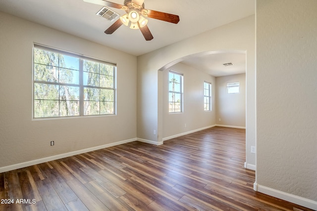 empty room featuring dark wood-type flooring and ceiling fan