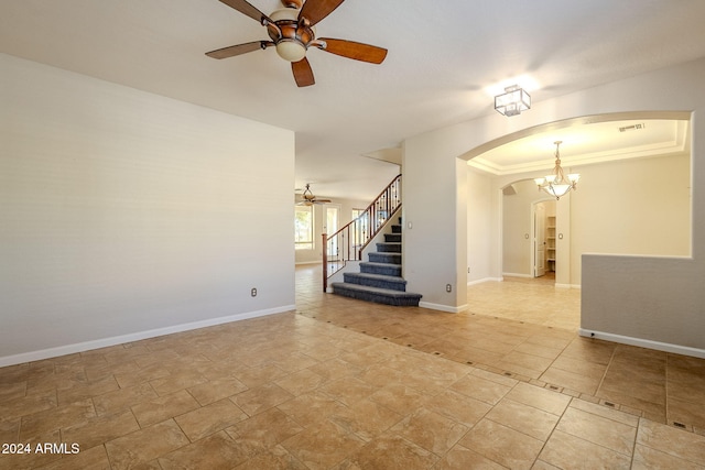 unfurnished room featuring ceiling fan with notable chandelier and crown molding