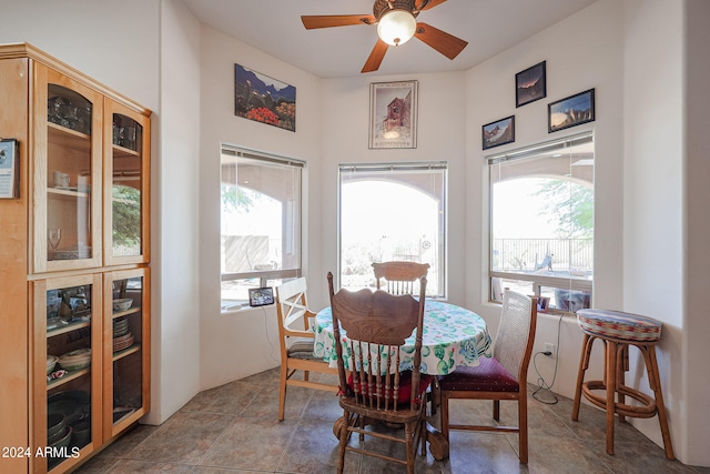 tiled dining space featuring ceiling fan