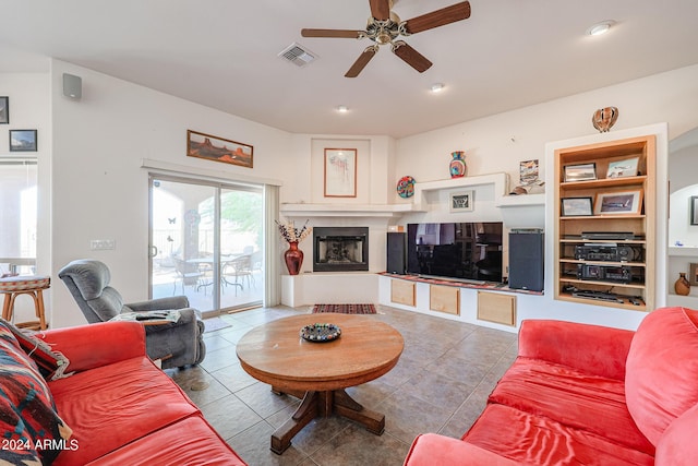 1880 W Roderick Ln, Wickenburg, AZ 85390 - living room featuring tile patterned flooring, a glass covered fireplace, ceiling fan, and visible vents