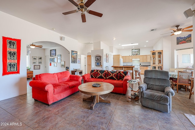 tiled living room with ceiling fan