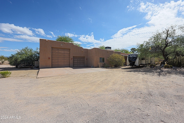 pueblo-style home with a garage