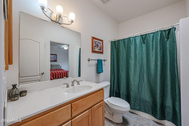 bathroom with a shower with shower curtain, vanity, ceiling fan, tile patterned flooring, and toilet