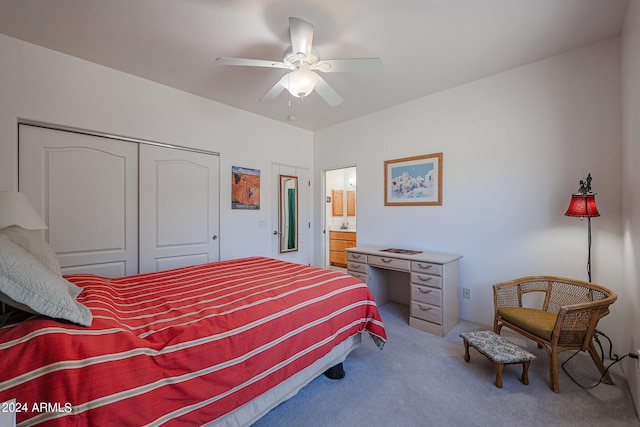 carpeted bedroom with ceiling fan, a closet, and ensuite bathroom