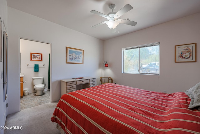 bedroom featuring ensuite bath, ceiling fan, and light carpet