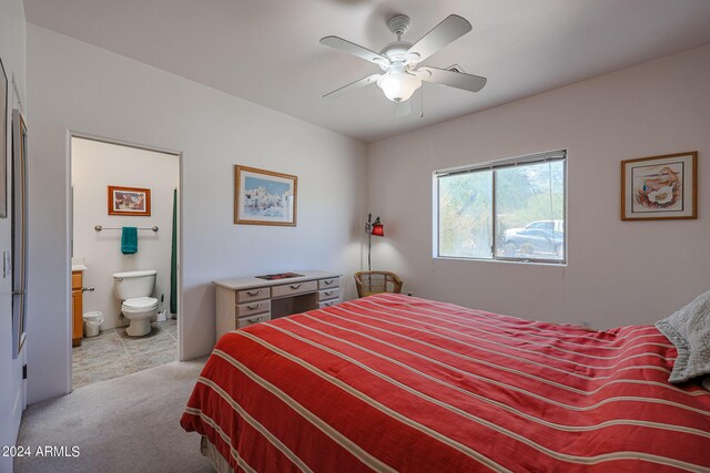 1880 W Roderick Ln, Wickenburg, AZ 85390 - bedroom with connected bathroom, light colored carpet, and ceiling fan