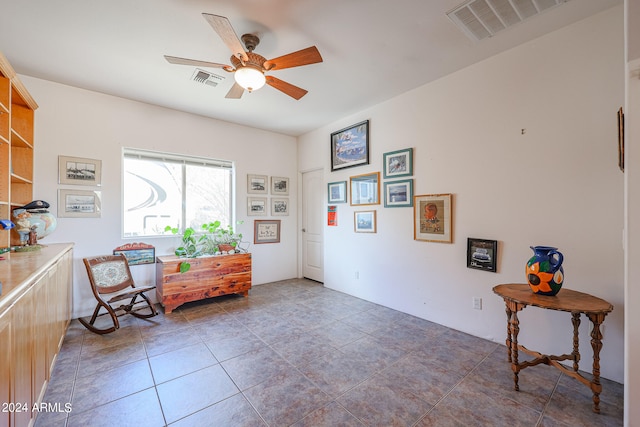 sitting room featuring ceiling fan