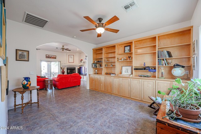 1880 W Roderick Ln, Wickenburg, AZ 85390 - living room with visible vents, arched walkways, and a ceiling fan