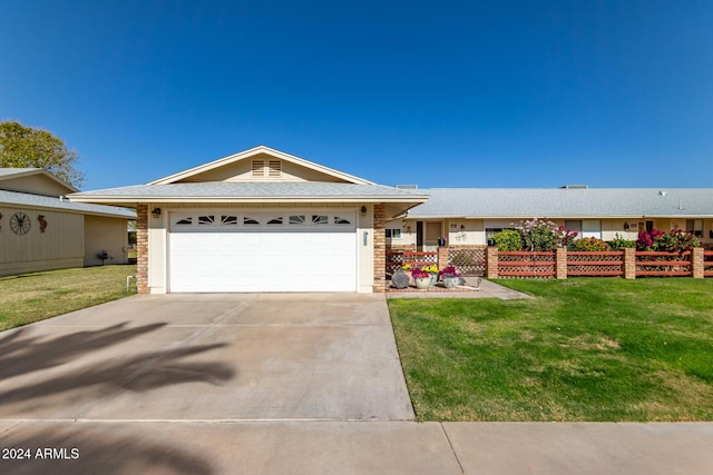 single story home featuring a garage and a front lawn