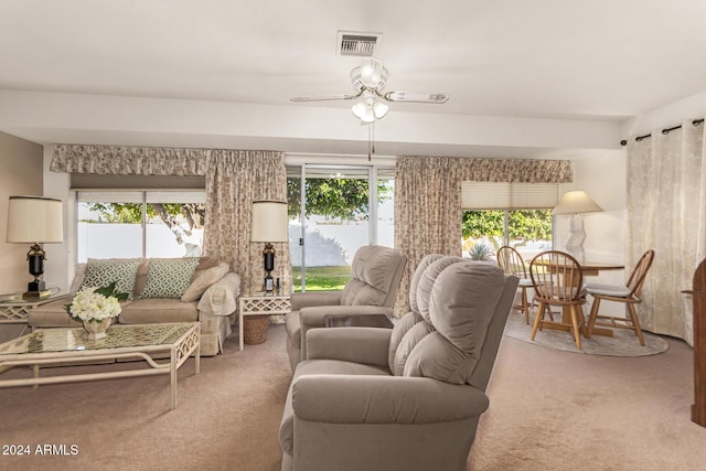 carpeted living room featuring ceiling fan and a healthy amount of sunlight