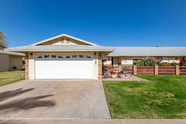 single story home with a front yard and a garage