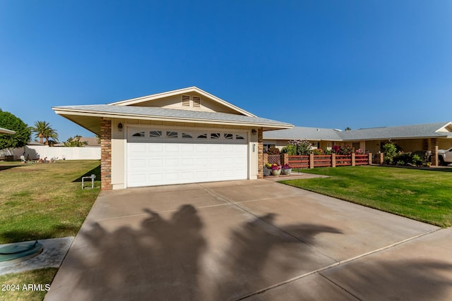 ranch-style house with a garage and a front lawn