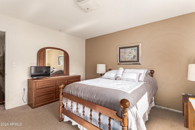 bedroom featuring light carpet