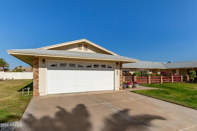 ranch-style house featuring a front lawn and a garage