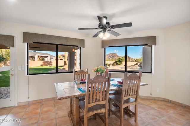 dining area with light tile patterned floors and ceiling fan