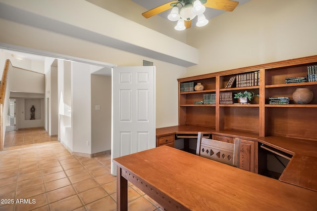 tiled office space featuring ceiling fan