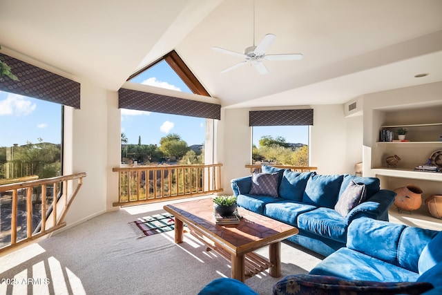 carpeted living room with vaulted ceiling and ceiling fan