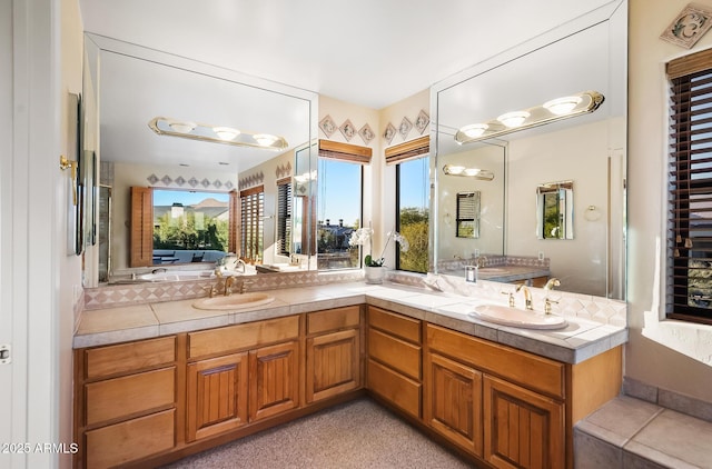 bathroom featuring vanity and a bath