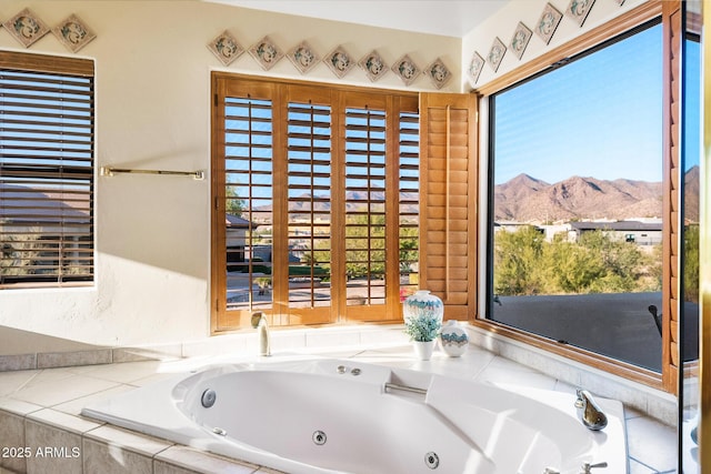 bathroom featuring a mountain view and a tub to relax in