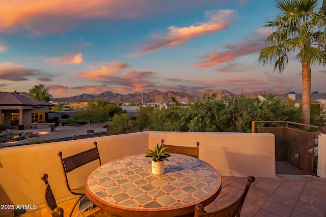 patio terrace at dusk with a mountain view