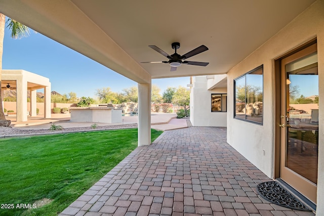 view of patio with ceiling fan and exterior kitchen