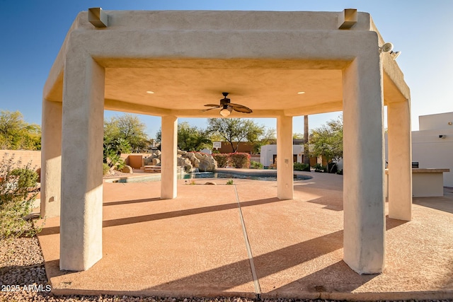 view of patio / terrace featuring ceiling fan and a fenced in pool