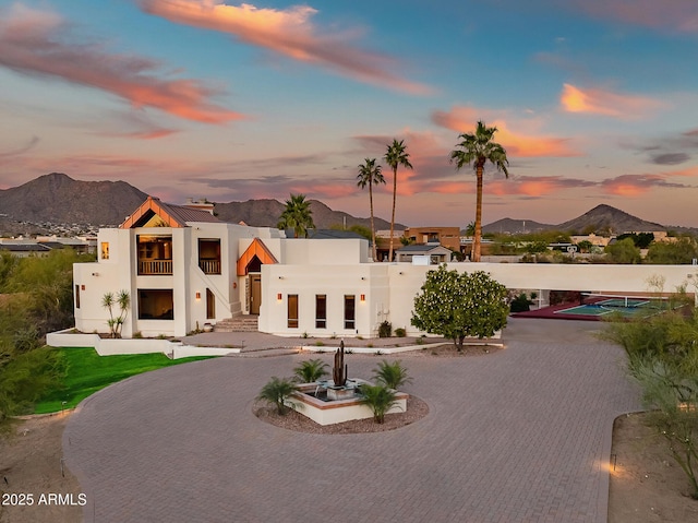 view of front of home with a mountain view and a balcony