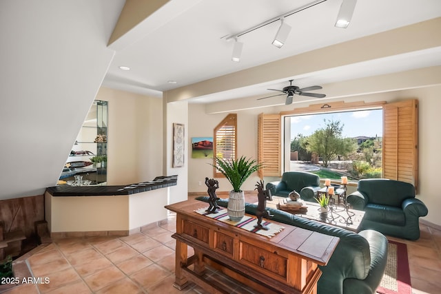 living room with light tile patterned flooring, track lighting, and ceiling fan