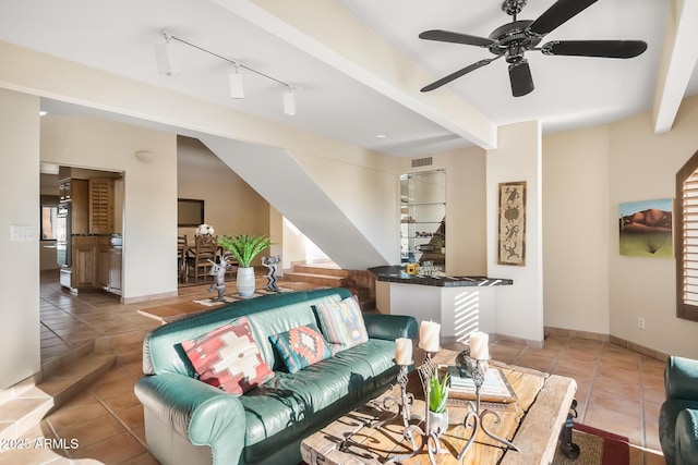 tiled living room with beamed ceiling, ceiling fan, and rail lighting