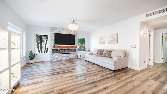 unfurnished living room with light hardwood / wood-style flooring and a notable chandelier