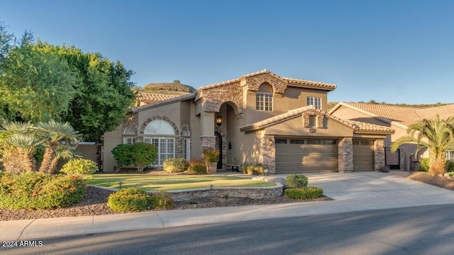 mediterranean / spanish-style house with a garage