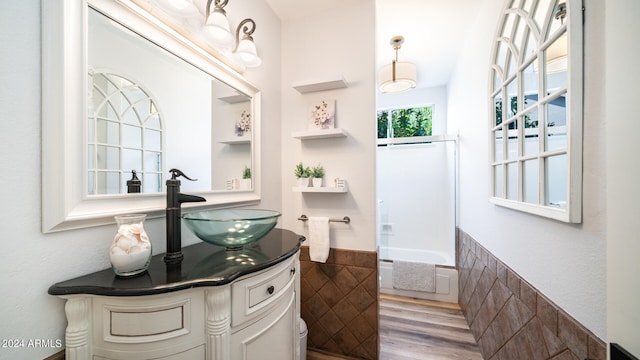 bathroom featuring vanity, a bathing tub, toilet, and wood-type flooring